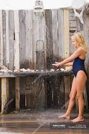Little blonde girl standing under a beach shower — childhood, hygiene -  Stock Photo | #222917842