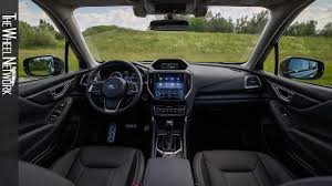 The interior is adorned with stitching and blue inserts, reminiscent of another hybrid vehicle: 2020 Subaru Forester E Boxer Interior Youtube