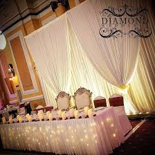 Check out these amazing wedding head table decoration ideas and inspire to dine in style at your own reception. Diamond Weddings Tied Simple Drape Backdrop And Bridal Table Diamondweddings Weddingdecor Weddingday Backdrop Headtable Drapes Curtains Instalike Instalove Instadaily Instapic Potd Photo Pic Photography New Bride Wedding Decor