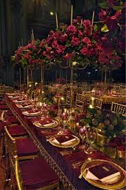 A Long Table Is Decorated With Candelabra Covered In Red Roses And Low Arrangements Of Flowers And Fr Red Wedding Decorations Wedding Table Wedding Decorations