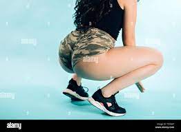 Closeup Of Woman Dancing Twerk Booty On Blue Background Young Girl Wearing Camouflage Shorts Black Top And Running Shoes Movement Healthy Lifestyl Stock Photo Alamy