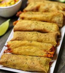 Add shredded cheese and make a thin roll from each filled tortilla. 20 Minute Air Fryer Taquitos With Shredded Mexican Chicken And Cheese