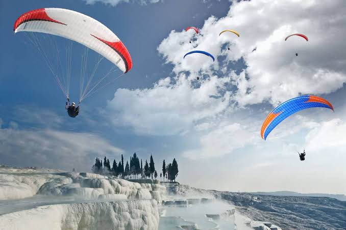 Aerial view of Pamukkale white terraces during paragliding flight
