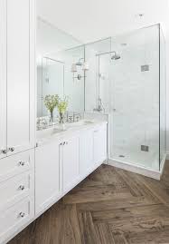 For your bathroom, wood tile is preferable because it handles moisture better. Master Bathroom With Herringbone Wood Floor Marble Shower And Countertops White Cabinets Do Bathroom Remodel Master Bathrooms Remodel Herringbone Wood Floor