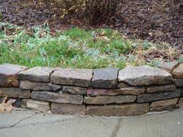 Rock Around Flower Bed Drystack Wall Border Around Natural Areas And Flower Beds Create A Stone Walls Garden Stone Landscaping Stone Flower Beds