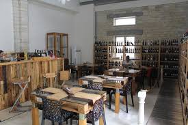 A serpentine table rounds the corner between two banquet tables for a bar, with table skirts. Inside Tables And Chairs For Inclement Weather Picture Of Wine Bar Italiano 100 Limassol City Tripadvisor