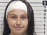 Florida teen smiles in mugshot after her ear was bitten off in a brawl