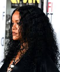 Bang bang into the room. Rihanna Long Curly Black Hairstyle With Layered Bangs