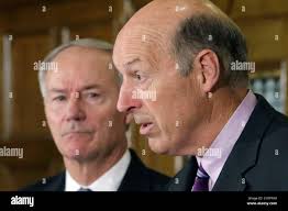 Arkansas Department of Human Services Director John Selig, right, speaks as  Gov. Asa Hutchinson listens at the Arkansas state Capitol in Little Rock,  Ark., Tuesday, Aug. 18, 2015. Hutchinson said the state