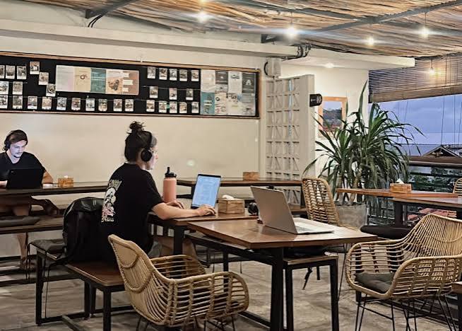 People working from a laptop-friendly cafe