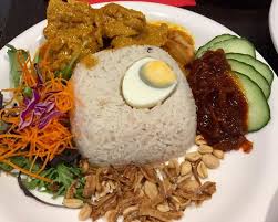 Nasi lemak is a common breakfast dish, sold early in the morning at roadside stalls in malaysia, where it is often. Special Chicken Nasi Lemak Rice Cooked In Coconut Milk Served With Curry Chicken Spicy Chilli Sambal Peanuts Ikan Billis Anchovies And Fresh Veges Huge Serve Picture Of