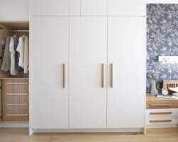 They're bright, clean, and don't require a lot of stressful color decisions when decorating (because literally, everything is white). Clean White Wardrobe With Wooden Handles Bedroom Cupboards Bedroom Cupboard Designs Cupboard Design