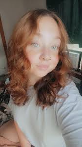 What haircut and color would suit my face and natural curls?