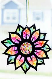 Over 50 stained glass and suncatcher crafts kids can make, including nature suncatchers, melted crayon stained glass, and even stained glass bunting. Tissue Paper Stained Glass Flower Craft Three Little Ferns Family Lifestyle Blog