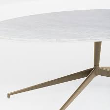 Dowel legs and an oval top give the coffee table the silhouette of authentic pieces from the 1950s and '60s. Mid Century Oval Marble Pedestal Coffee Table