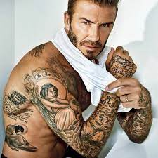 The back of the photo of david beckham visible tattoo with a cross with wings and the name of the second son of «romeo». Mytattoo Com The Story Behind David Beckham S Tattoos