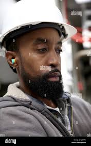 Marine engineer in ship's engine room Stock Photo