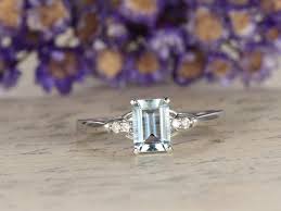 For instance, a ring might have an aquamarine gemstone surrounded in black or white diamonds. Amazon Com Solid 14k White Gold Natural Blue Aquamarine Engagement Ring 5x7mm Emerald Cut Gemstone Cluster Diamond Wedding Ring Plain Band Claws Solitaire Anniversary Gift Bridal Promise Handmade Products