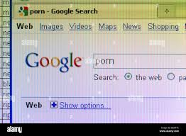 screenshot of search for internet porn on google search website with  partial spreadsheet at work showing for editorial use only Stock Photo -  Alamy