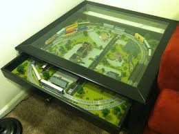 This coffee table layout includes backgrounds of mountains and buildings. Coffee Table Train Set Ikea Hackers N Scale Model Trains Model Train Sets Train Layouts