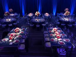 Pin spot lighting illuminating wedding centerpieces and floral arrangements at a NJ reception