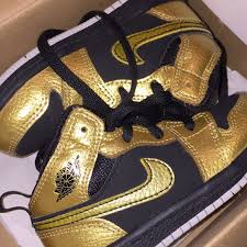The shoe's upper is built with patent leather, finished in black and highlighted by metallic gold on the 'wings' logo, swoosh branding, collar and tongue tag. Jordan Shoes Black And Gold Jordans Poshmark