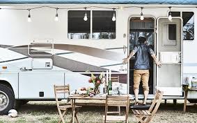 Outdoor Furniture Outside A Motorhome Decorated With Lights Where Karlton Stands In The Doorway Tiny House On Wheels House On Wheels Ikea