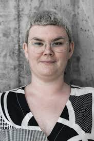 Man smiling wearing maroon V-neck shirt photo