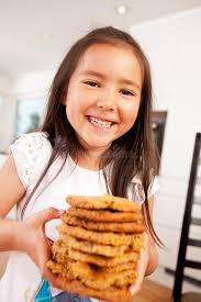Happy Cute Girl Holding Cookies Stock Photo