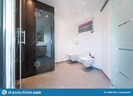 The number of floating glass shelves to add in your bathroom really depends on how many items you're planning on storing on them and the layout of the actual room: Modern Bathroom Glass Door Design