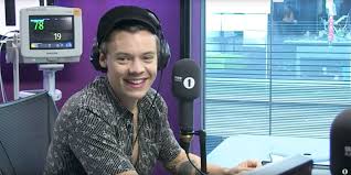 Harry styles wearing black vertical striped double breasted blazer, black dress shirt, black vertical striped dress pants, black leather chelsea boots. Harry Styles Is Into Ryan Gosling And Chelsea Boots Harry Styles Heart Monitor Challenge Bbc Radio 1 Video