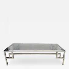 Gracing your interior with sleek minimalism, this rather narrow x base console table is a fine pick when you want to tie the updated decor together. A Modish French Chrome And Glass Rectangular Coffee Table