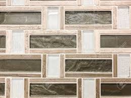 Glass backsplashes don't need fabric behind them to be beautiful. Green Stone Tile Mixed With Beige Ceramic Tile And Clear Glass Stock Photo Picture And Royalty Free Image Image 113376649