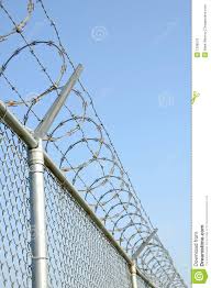 Photo About Security Fence With Razor Wire Image Of White Field Sharp 1338570 Security Fence Fence Design Fence