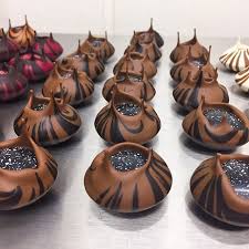 With Master Chocolatier Kris Schoofs Chocolates Volcanoes 4 Flavours Stroh Rum Kumabo 80 Coconut Batida De Coc Yummy Food Chocolatier Chocolate Lovers