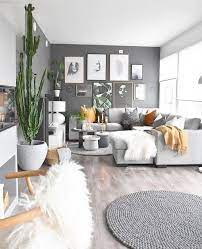 Grey accent wall living room ideas. Gray Living Room Stained Hardwood Floors Dark Gray Accent Wall Gallery Wall College Apartment Decor Apartment Decorating On A Budget House Interior