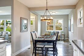 To the left, the first kitchen island's black wood paneling is topped with agatha black granite, lit by two traditional profiled brass and glass hanging pendant lamps. Interior 101 Transitional Style Homelane Blog