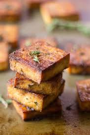 This Flavor Packed Baked Tofu Is Soaked In A Marinade Of Zesty Lemon Juice Zippy Garlic And Savory Herbs Then Baked To Perfec Tofu Dishes Baked Tofu Recipes