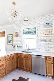 Here, the backsplash is tiled with varying shades of teal to temper the rich wood tones in. Rental Kitchen Decor Ideas Oak Wood Finish Cabinets Apartment Therapy