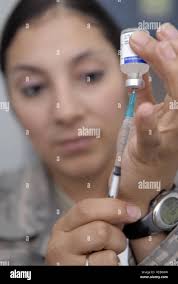 Senior Airman Sonia Vega, 332nd Expeditionary Aerospace Medical Squadron,  gauges the right amount of vaccine needed for a shot at Balad Air Base,  Iraq, Oct. 19. The main vaccinations administered are Anthrax