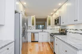 Updated baths, newer kitchen cabinets with granite countertops and new frigidaire appliances, replacement windows, yellow pine floors and enclosed finished porch. 21 West Woods Yarmouth Ma