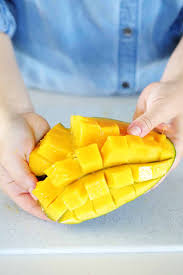 One of the easiest ways to cut a mango is to keep the skin on and vertically slice off each half away from the pit. How To Cut A Mango Two Easy Ways Bowl Of Delicious