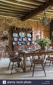 Decorative Chinaware On Antique Wooden Dresser With Table And Chairs In Restored 16th Century Farmhouse Stock Photo Wooden Dresser Table And Chairs Decor