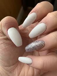 You can either grow them really long or keep them relatively shorter. White Coffin Nails With Silver Glitter On Ring Finger Nailstip