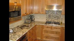 The subtle gray veining of the backsplash tile does not clash or compete with the granite's dramatic patterning, but rather enhances the white veining. Backsplash Ideas For Black Granite Countertops Youtube