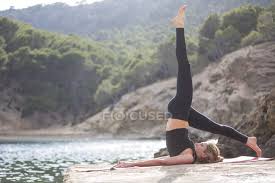 Yoga for windsurfers, yoga for kitesurfers and. Young Woman With Leg Raised Practicing Yoga Position On Sea Pier Majorca Spain Yoga Mat Well Being Stock Photo 180124504