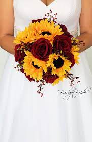 Sturdy petals, bright color, and instant charm. Sunflowers And Dark Red Roses Accented With Red Berries Sunflower Themed Wedding Sunflower Wedding Bouquet Flower Bouquet Wedding