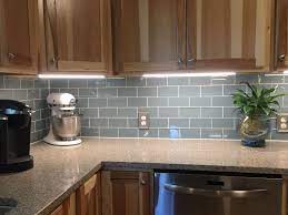 1, glass mosaic tile backsplash will be rich and colorful in the shower room and the living room lamp, and it has a good visual impact. Smoky Blue Glass Tile Backsplash And Under Cabinet Lighting Light Kitchen Cabinets Creative Kitchen Backsplash Kitchen Backsplash