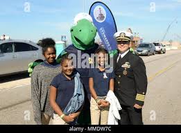 171020-N-FF404-122 NORFOLK, Va. (Oct. 20, 2017) Capt. Rich McDaniel,  commanding officer of Naval Station Norfolk, poses for a photo with  students and Stewie, the U.S. Navy's environmental turtle mascot, in front  of the U.S. Navy's "Stewards of the Sea ...