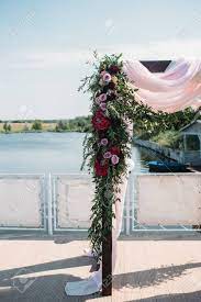 Maybe you would like to learn more about one of these? Wedding Arch Decorated With Burgundy Flowers And Eucalyptus On The Riverside Stock Photo Picture And Royalty Free Image Image 96783961